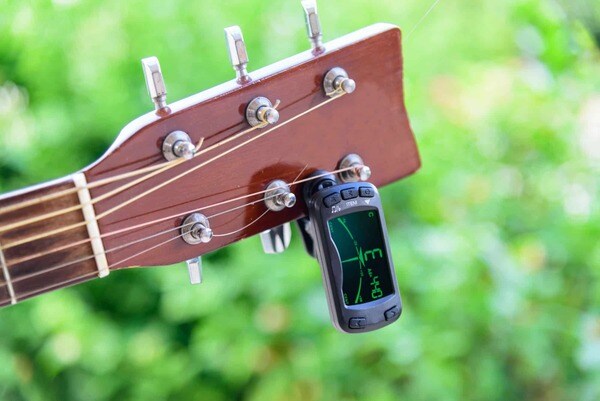 Dùng máy Tuner để hỗ trợ chỉnh dây đàn Guitar (Nguồn: Internet)